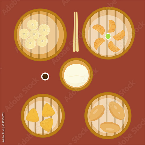 Top view of traditional Chinese dumplings  with soy sauce, chopsticks and a bamboo steamer
