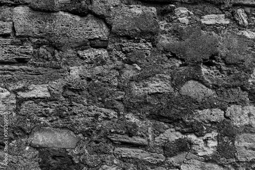 Old aged grunge deserted cobble boulder dry wall of the castle town. Crushed rugged relief grungy block, scary ruined quarry stone, built older decrepit cement waste facade, dirty crumbling fort side