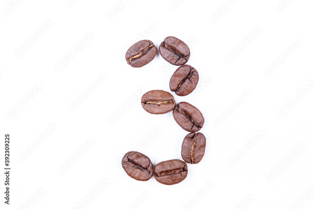 Naklejka premium Number three made of coffee beans on a white background. Coffee beans isolated on white. Macro.