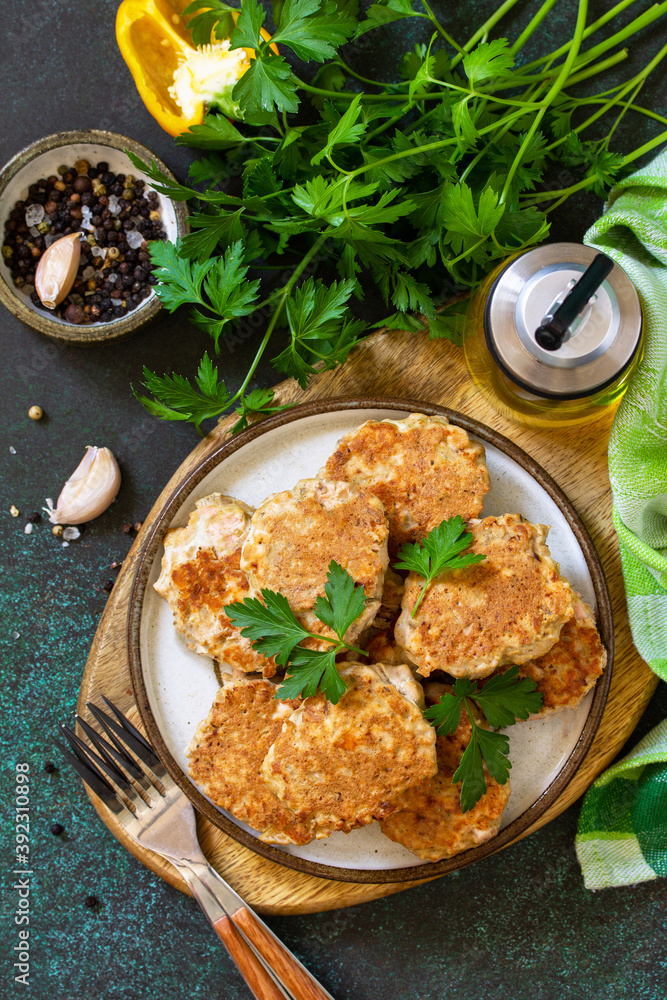 Healthy vegan food. Red fish cutlets on a dark stone or slate table. Top view flat lay background.