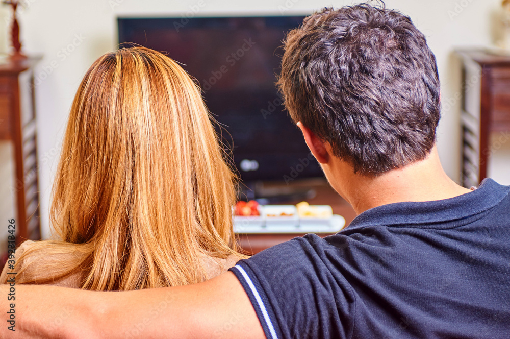 Fototapeta premium Couple watching having a movie night at home