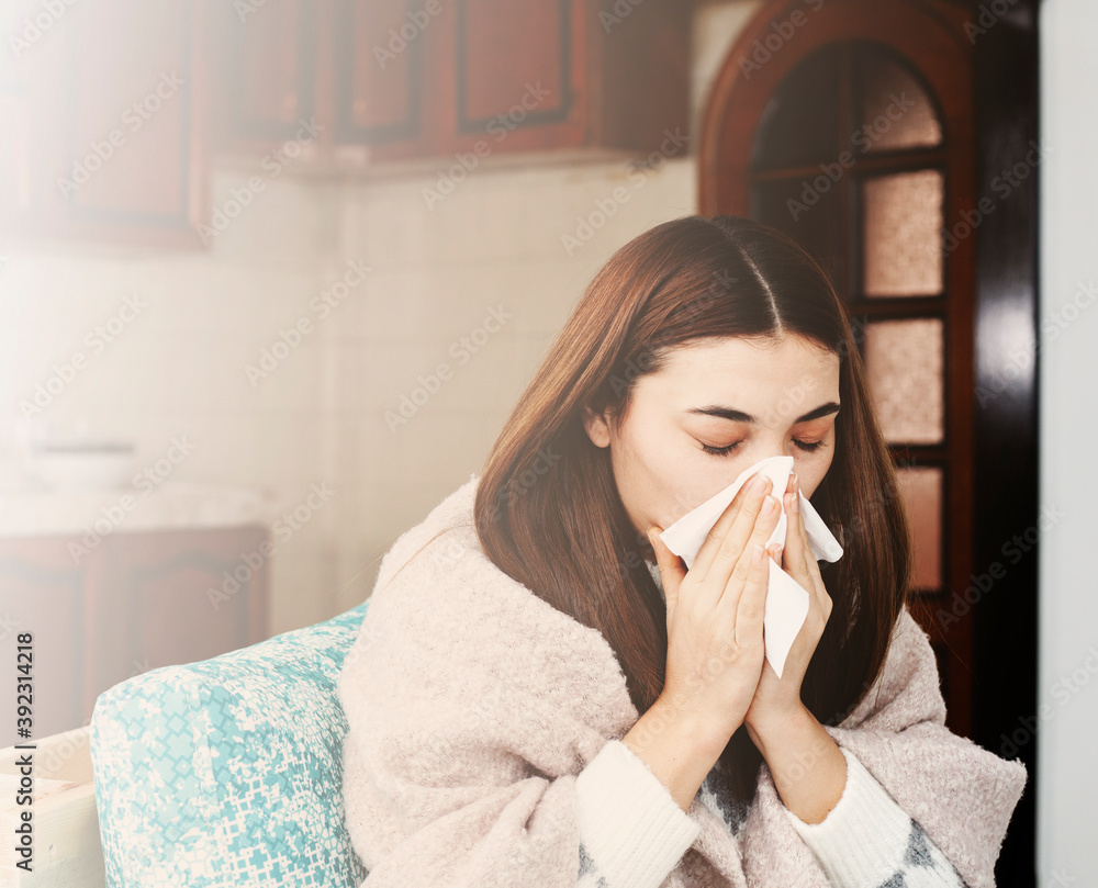 Sick young woman wipes her nose with a handkerchief Sick young woman wipes her nose with a handkerchief