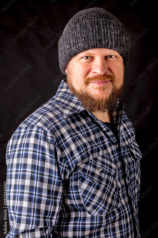 Fototapeta premium Solid bearded man in a wool cap portrait