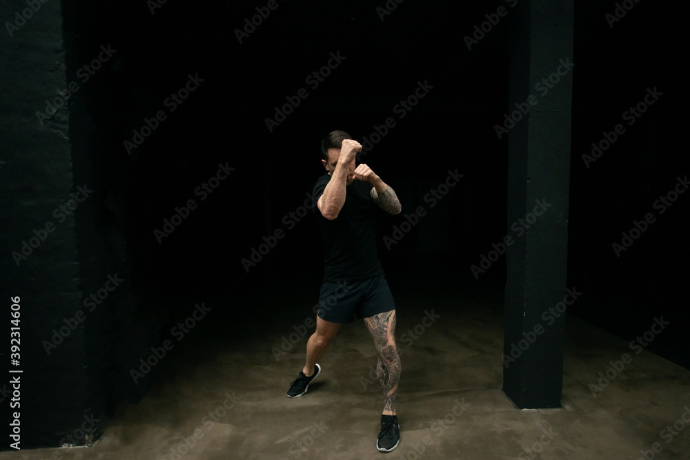 Kickboxer practicing punches in gym Kickboxer practicing punches in gym