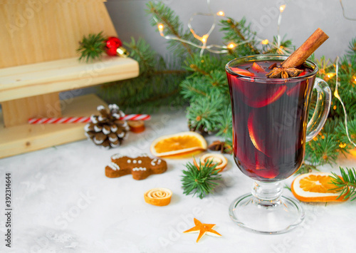 Christmas mulled red wine with spices and oranges on a wooden rustic table.New Year traditional drinks