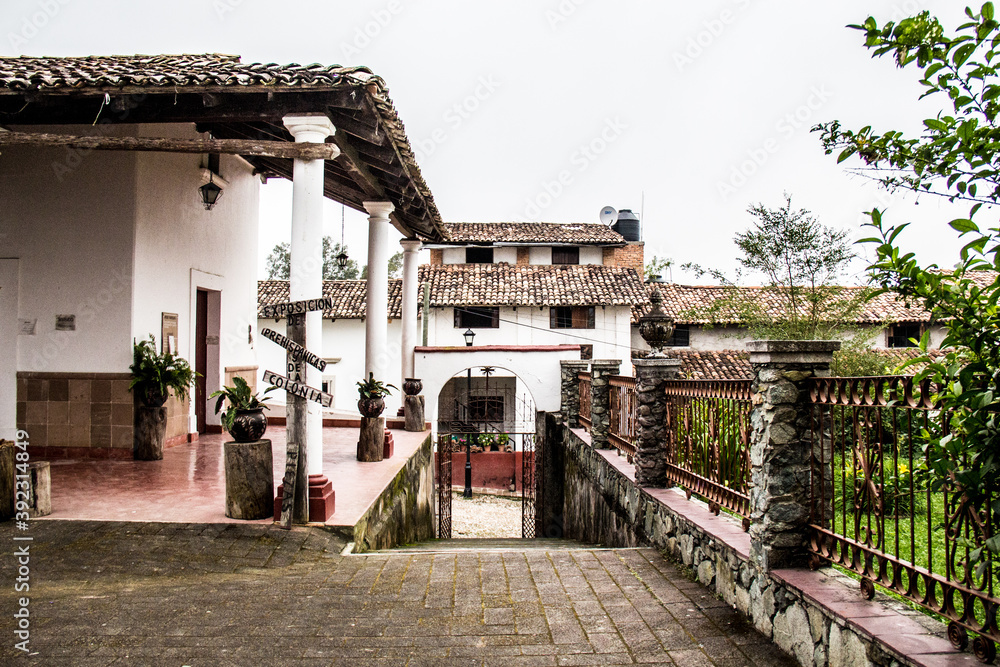 Fototapeta premium Cobbled street and adobe house in a Mexican old town, San Sebastian del Oeste, Jalisco, Mexico. Pueblo mágico, quiet street in a mexica town