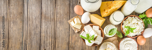 Set of Various Fresh Dairy Products - milk, cottage cheese, cheese, eggs, yogurt, sour cream, butter on wooden background