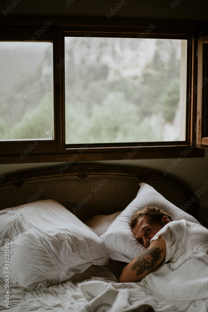 Man waking up in bed. Man waking up in bed.