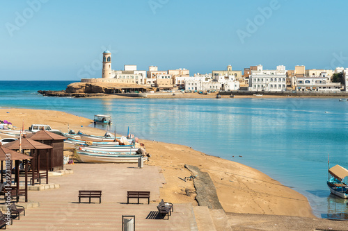 Landscape of Sur with Al Ayjah Lighthouse and fish boats on the beach, Sultanate of Oman