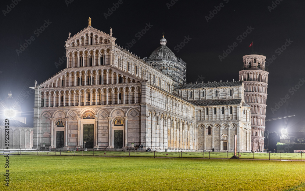 The cathedral of Pisa (Tuscany, Italy) and the leaning tower in the background during the night