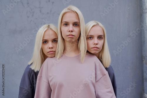 triplet sisters stand on the street in yoga clothes