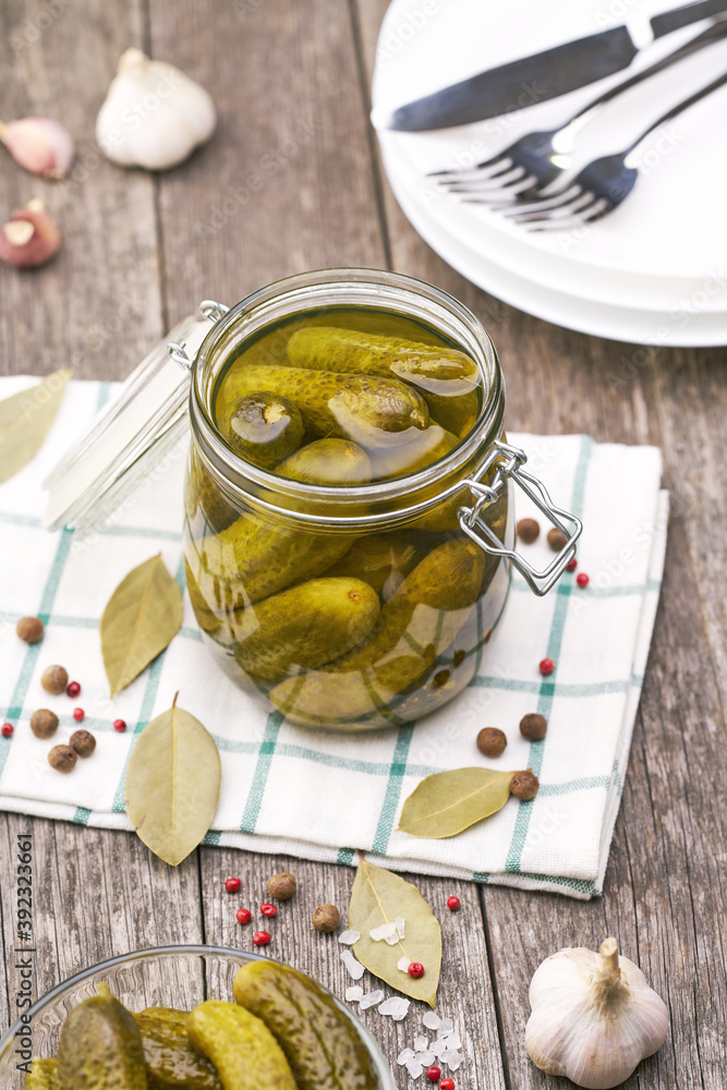Pickled cucumbers with herbs and spices, on a wooden background, top view. Pickled cucumbers with herbs and spices, on a wooden background, top view.