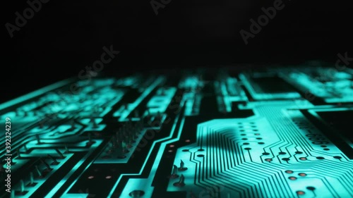 Circuit board electronics macro glowing in blue light photo