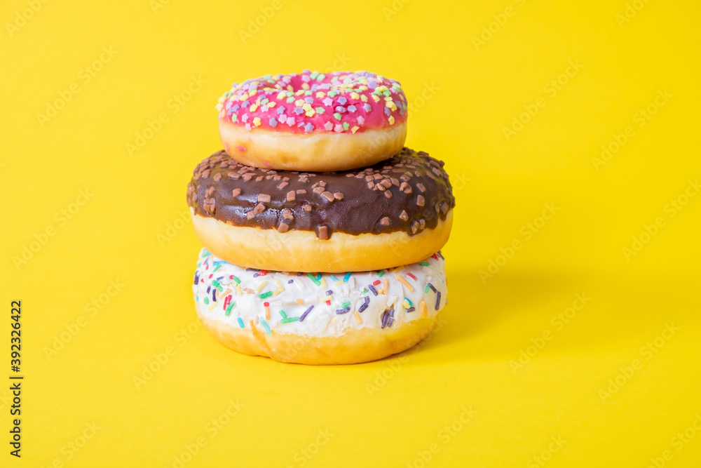Colorful delicious three donuts with sugar glaze on top