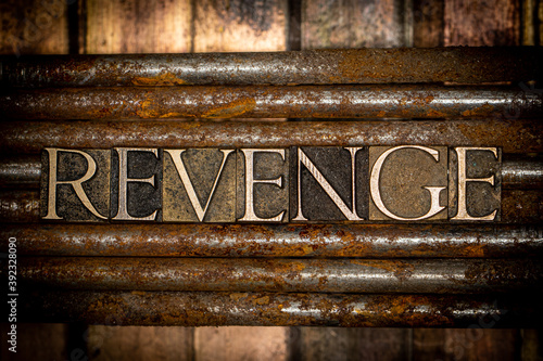 Revenge text message on vintage textured rusty nails over grungy bronze background