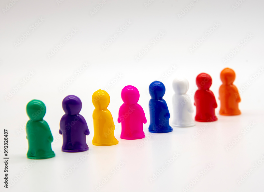 Miniature toy figures stand in formation on a white background. Miniature toy figures stand in formation on a white background.