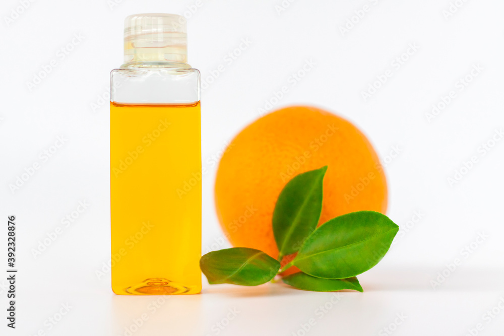 Orange oil for the body. Orange on a white background. Organic SPA cosmetics with herbal ingredients. Orange oil for the body. Orange on a white background. Organic SPA cosmetics with herbal ingredients.