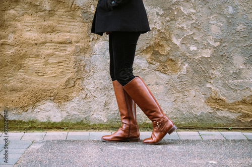 woman in boots walking on the street - wide photo