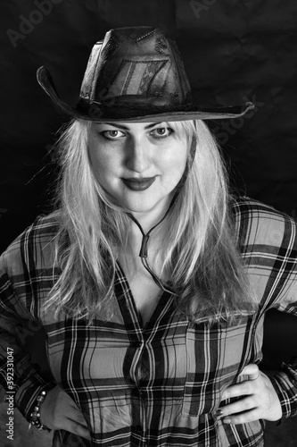 Attractive plump woman dressed in cow boy style photo