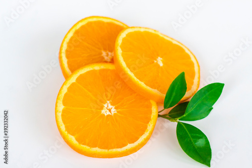 Cut orange on a white background. Natural orange fruit with cut slices. Vitamin C.