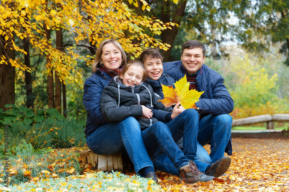 family relaxing outdoor in autumn city park, happy people together, parents and children, they talking and smiling, posing near yellow birch leaves, beautiful nature family relaxing outdoor in autumn city park, happy people together, parents and children, they talking and smiling, posing near yellow birch leaves, beautiful nature