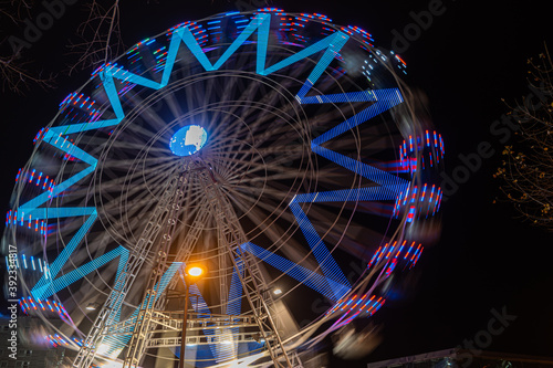 Fonte Nova's garden with Christmas market and colored ferris wheel near Ria de Aveiro at night