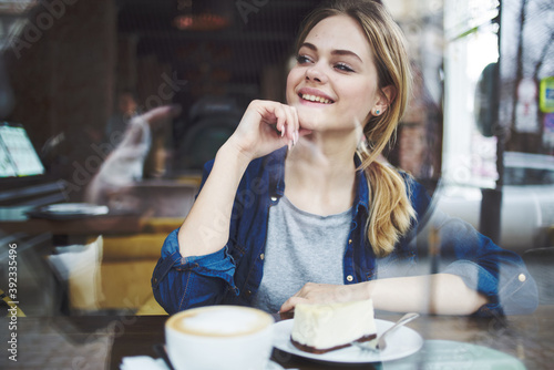 Cheerful woman cup of coffee cake lifestyle leisure