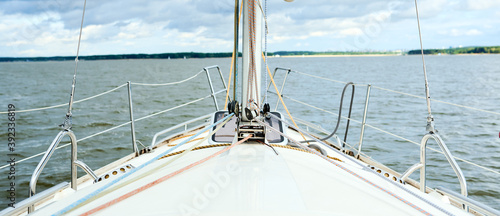 Bows of a yacht sailing offshore in summer in a first person point of view on a calm ocean