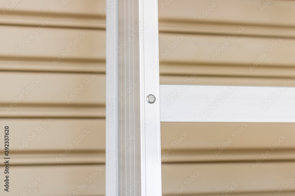 Fototapeta premium An aluminum foldable ladder on the wall