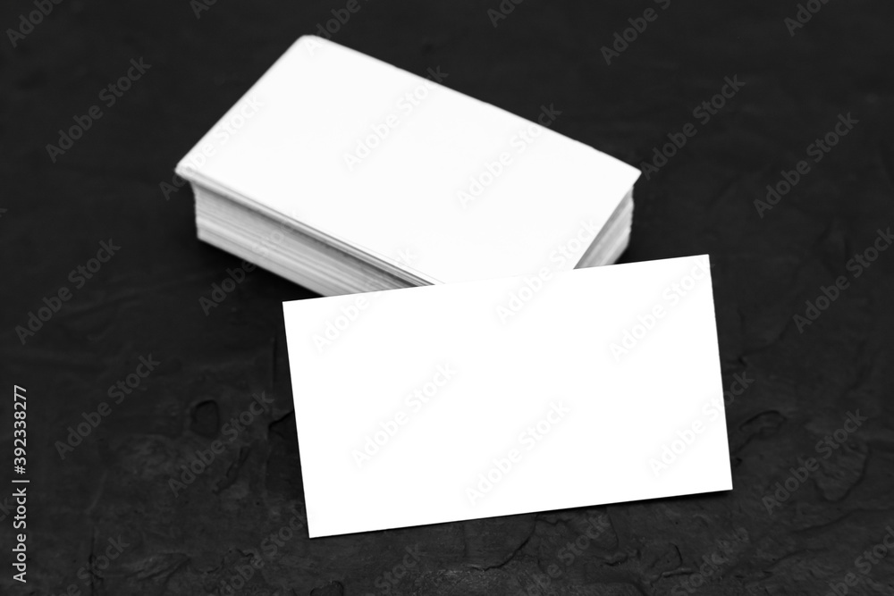 Business card template or mockup, white paper on a black background. Business card template or mockup, white paper on a black background.