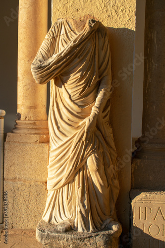 Vertical shot of a headless statue in the famous Roman ruins in Timgad, Algeria photo