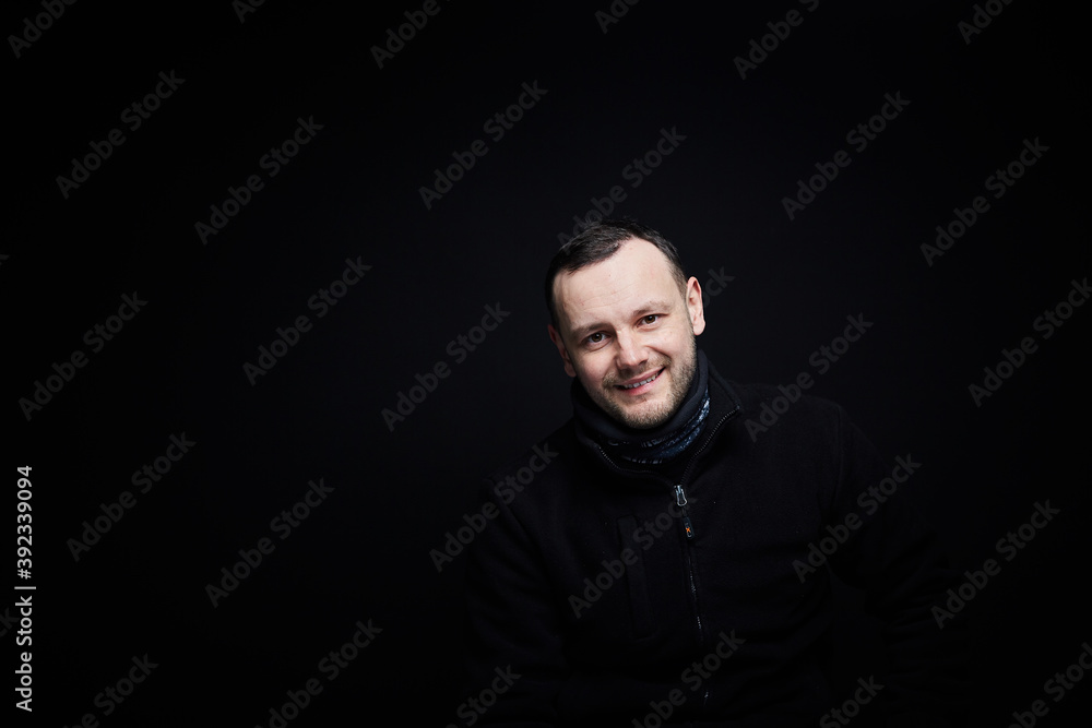Portrait of a smiling person on a black background 