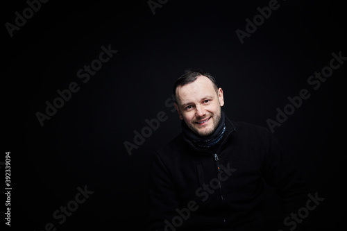 Portrait of a smiling person on a black background 