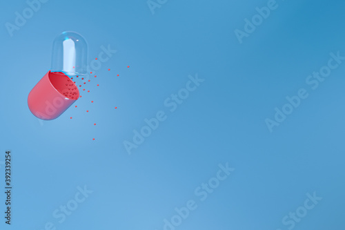 Opened 3d red and transparent medicine capsule on a blue background