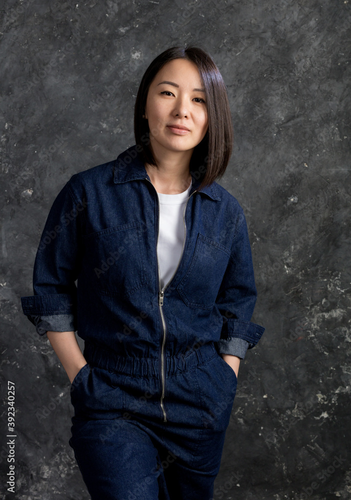 Beautiful korean woman dressed in jumpsuit studio portrait. Beautiful korean woman dressed in jumpsuit studio portrait.