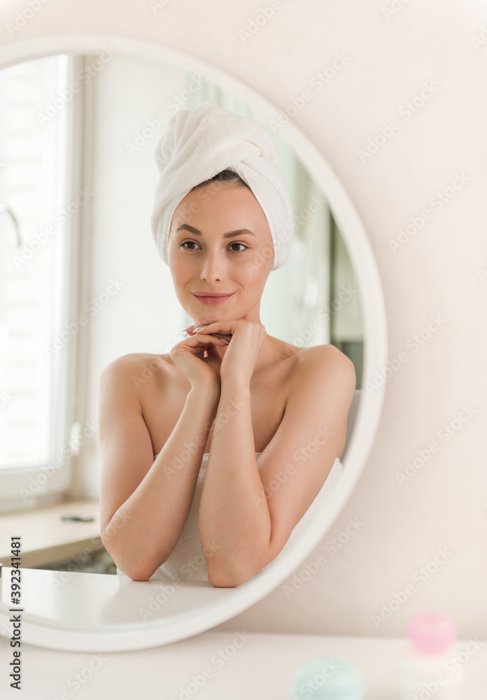 Beautiful model girl face with nude makeup on a flawless skin looking at camera with a serene expression. Beauty and Skincare concept. Beautiful model girl face with nude makeup on a flawless skin looking at camera with a serene expression. Beauty and Skincare concept.