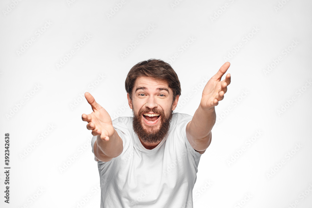 cheerful emotional bearded man gesturing with his hands close-up light background cheerful emotional bearded man gesturing with his hands close-up light background
