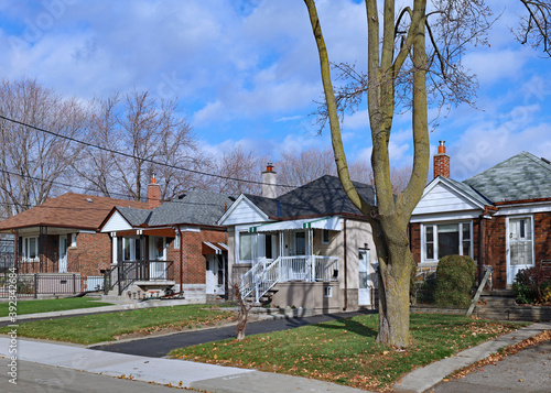 Street with row of modest 1950s style working class bungalows photo