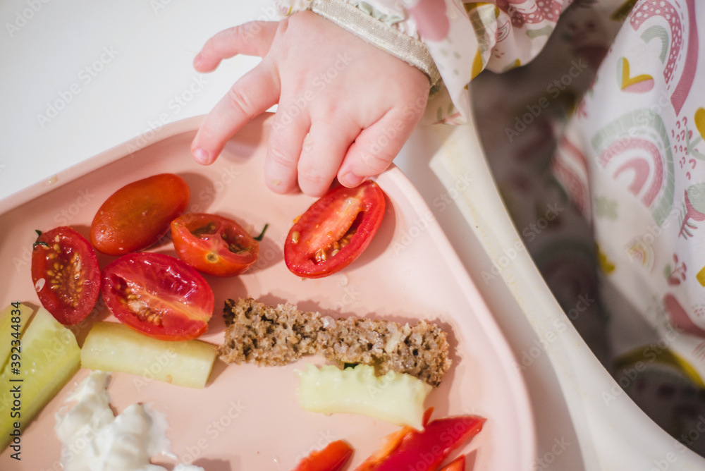 baby led weaning meal with cucumber, belly pepper, tomato Stock Photo