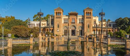 The Plaza de America and the Museum of Popular Arts in Seville, Spain. It is located in the Parque de Maria Luisa. panorama