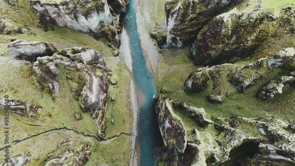 Slow drone shot looking down from above at Fjaðrárgljúfur canyon and river in Iceland Slow drone shot looking down from above at Fjaðrárgljúfur canyon and river in Iceland