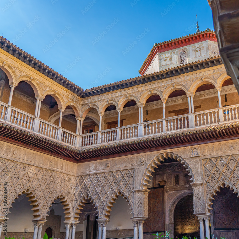 Palace of Alcazar, Famous Andalusian Architecture. Old Arab Palace in Seville, Spain. Ornamented Arch and Column.