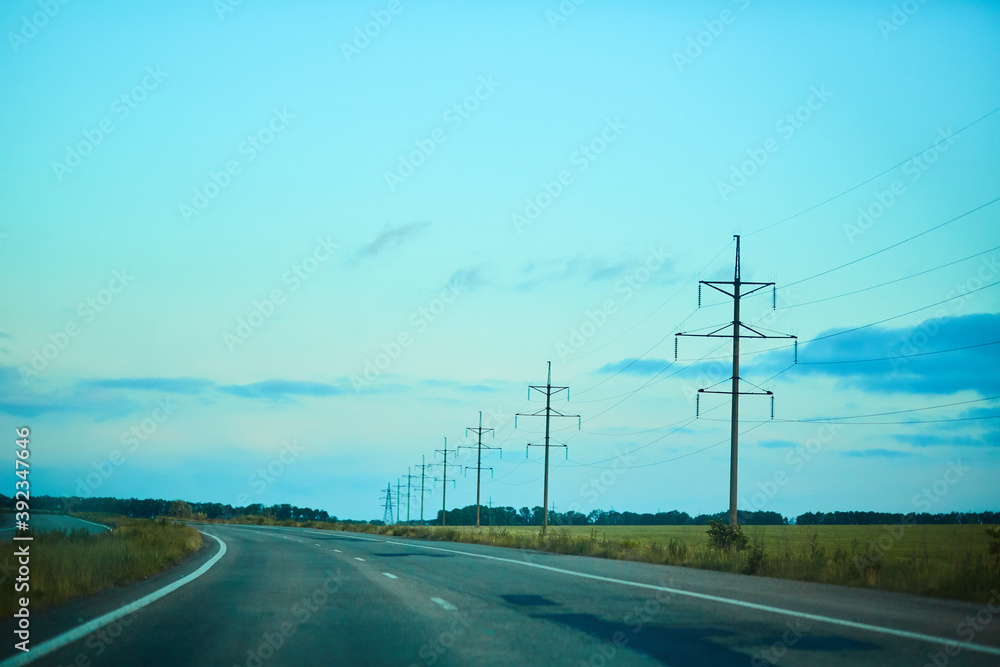 road to the sky and power lines in the field