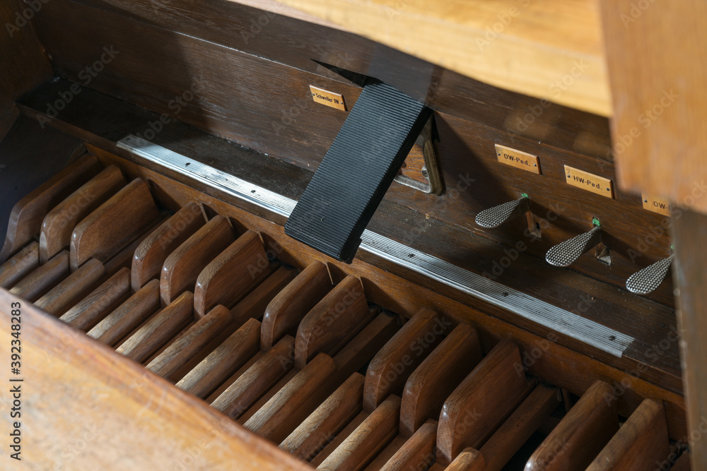Pedalboard with pedals, swell coupler and feet controls in the pipe organ console, St. Mary's Church of Gudow, Germany Pedalboard with pedals, swell coupler and feet controls in the pipe organ console, St. Mary's Church of Gudow, Germany