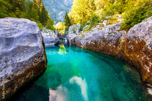 Wonderful turquoise Soca river in the Lepena valley, rocky part popular bathing place in summer photo