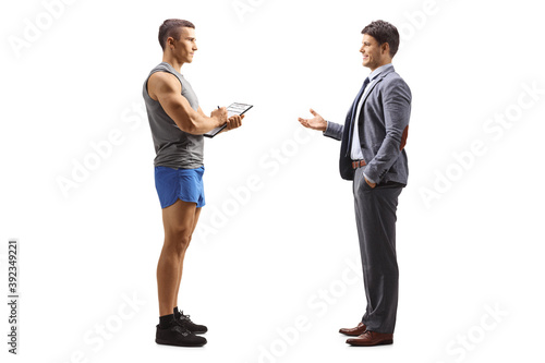 Full length profile shot of a businessman talking to a personal fitness trainer