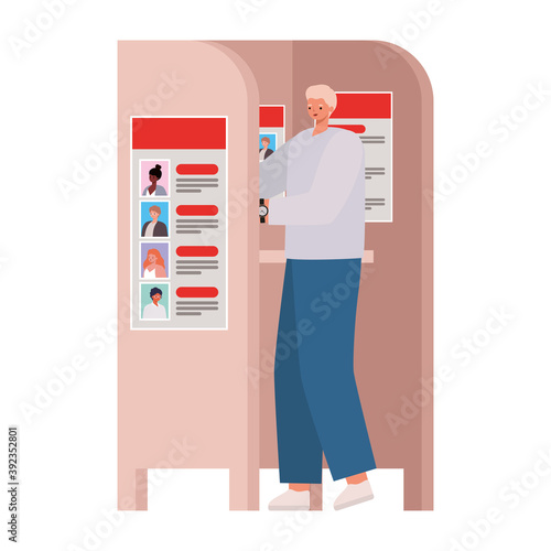 man voting with blonde hair and a gray coat in voting booth