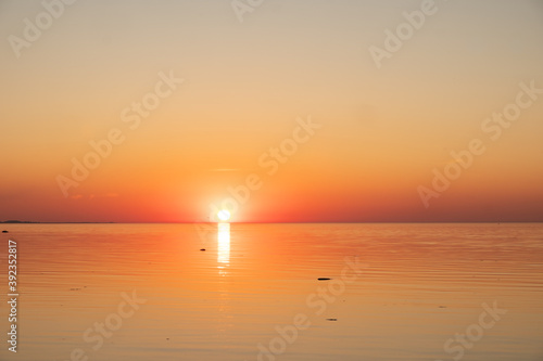 Amazing orange golden sunset over the sea. Summer sunset at the Baltic sea, Europe.