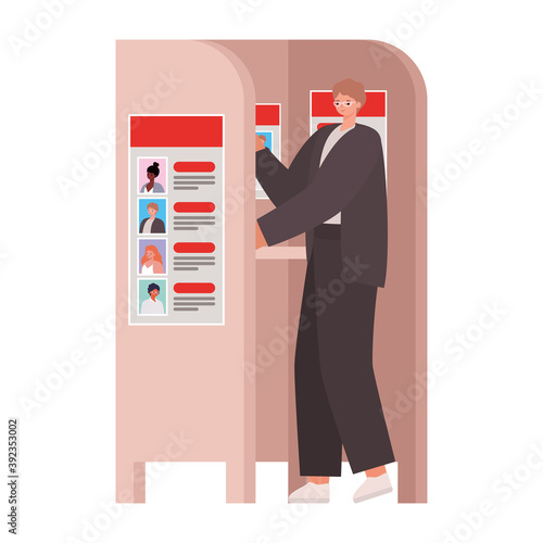 man voting with ligth brown hair and a dark suit in voting booth
