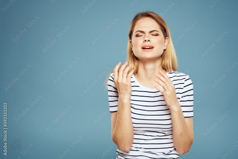 Emotional woman striped t-shirt lifestyle cropped blue background Emotional woman striped t-shirt lifestyle cropped blue background